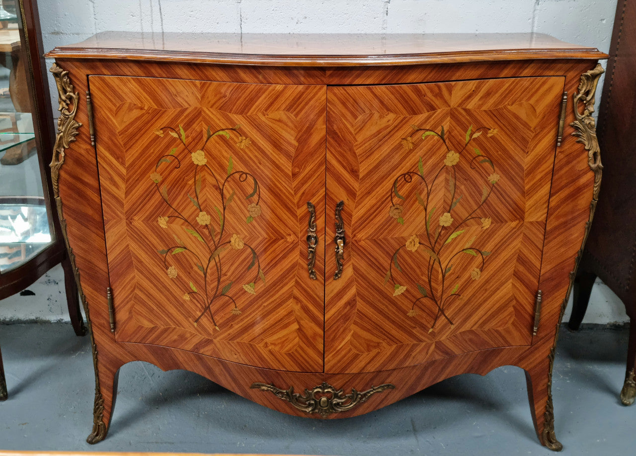 A high quality Louis XV style Kingwood marquetry inlay cabinet. Features extensive inlay inside the doors, and has beautiful ormolu mounts. In good original detailed condition.