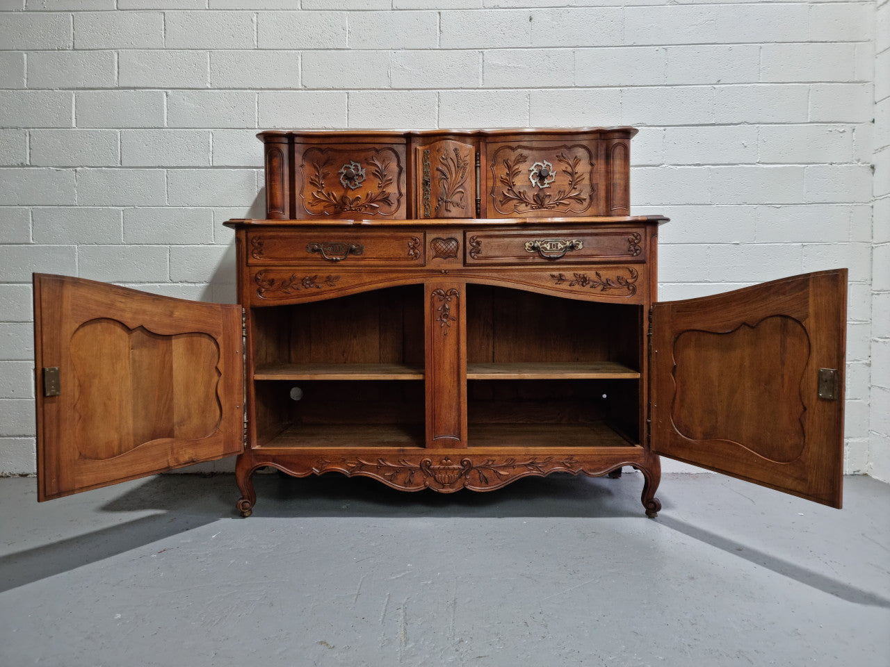 Stunning 19th Century French Walnut Buffet à Glissant from Provence, France. This is an exceptional charming piece and very functional with plenty of storage space, two large cupboards at the bottom, two drawers in the middle and two sliding doors either side at the top and finished off with a small central cupboard. In good original detailed condition.