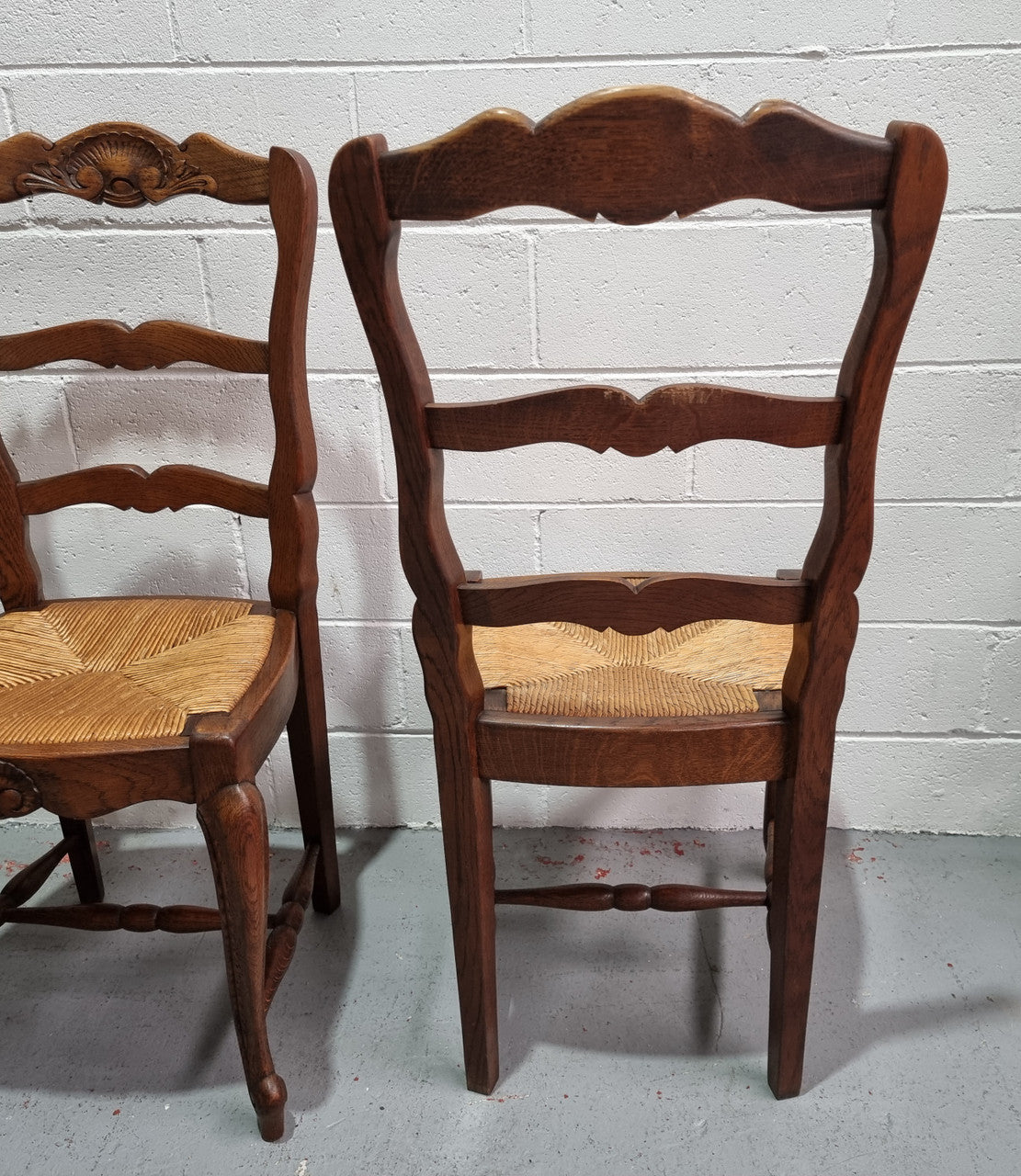 Lovely set of six French oak rush seated provincial dining chairs. They have been sourced from France and are in good detailed condition.