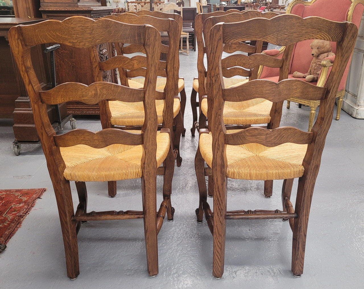 Set of six Louis XV style French Oak rush seat dining chairs. They are in good original detailed condition.