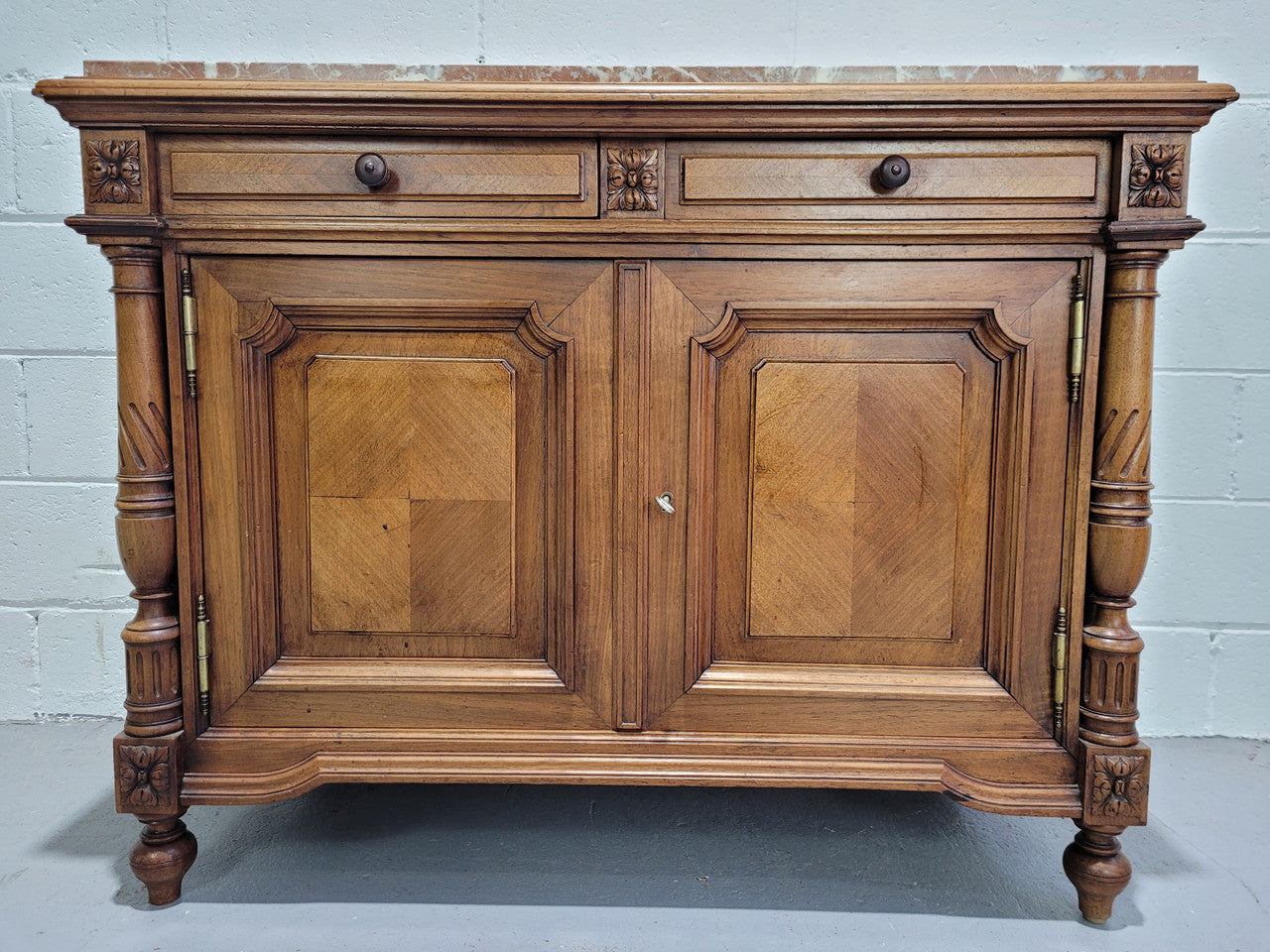 Stunning French walnut Henry II style marble top side cabinet with two drawers and two shelves inside. In good original detailed condition.