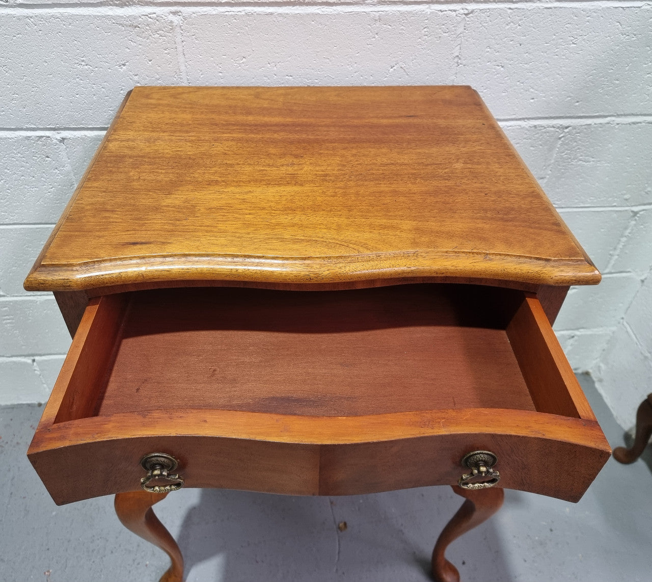 Antique Queen Anne style figured Walnut Bedside cabinet with 3 drawers. It is in good original detailed condition.