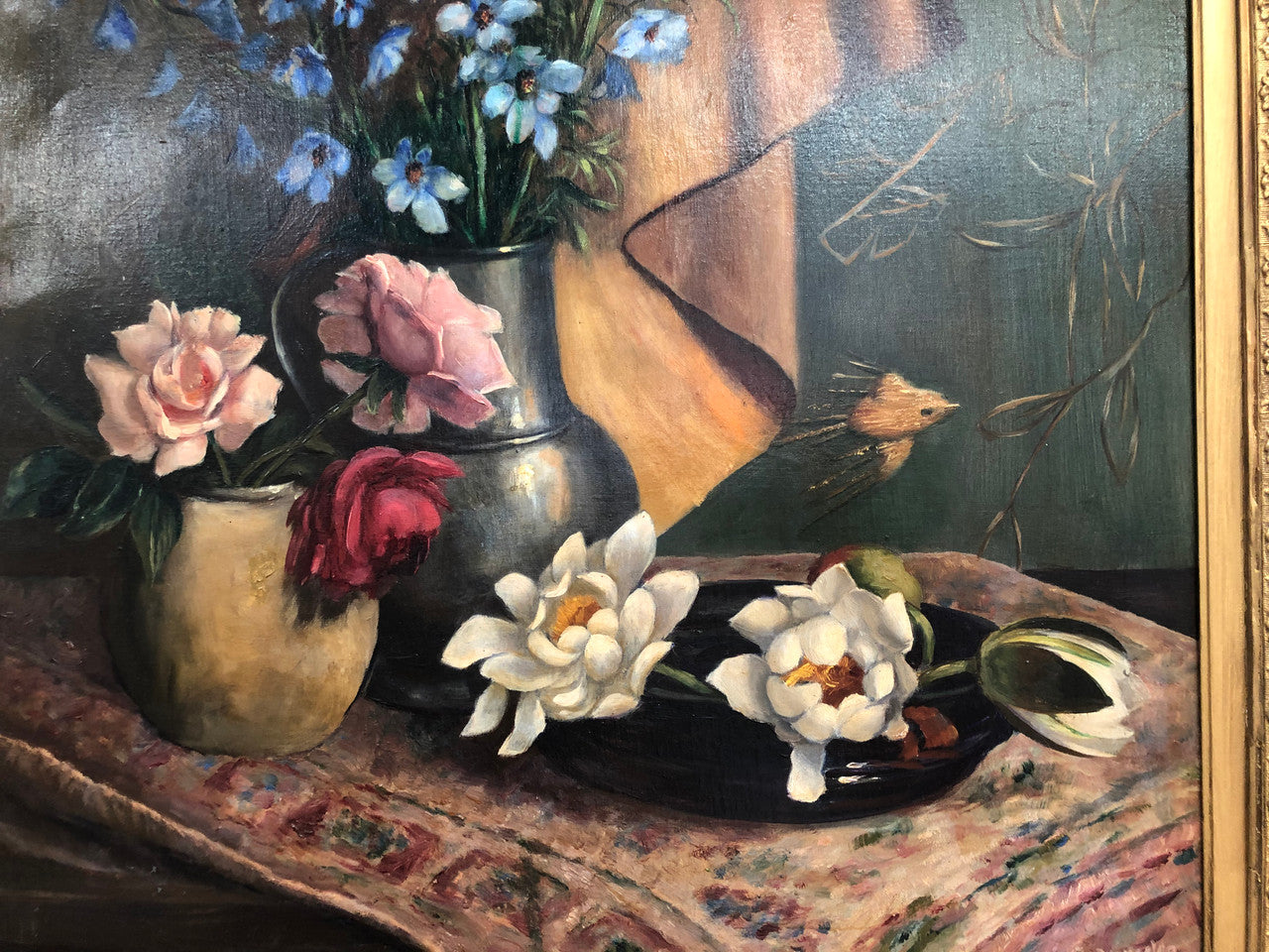 An Antique gilt-framed oil painting of floral still life. Housed in a double sweep gilt frame, signed and dated in good condition.