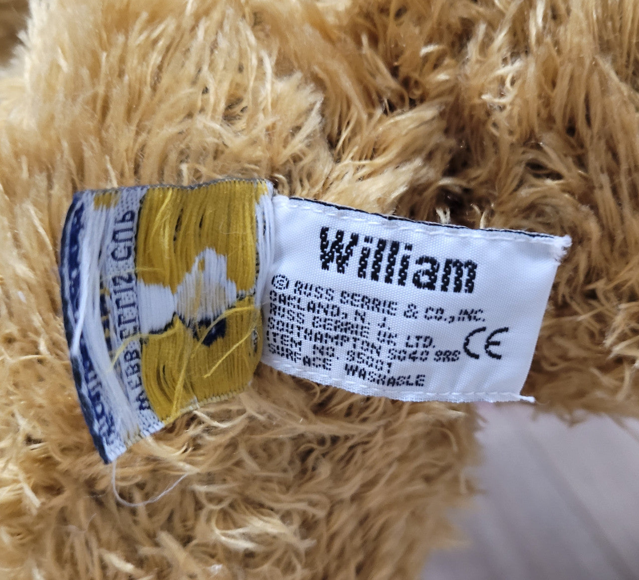 World Cup Rugby Bear. William by RUSS a special release for 2003. Limited to 5000 pieces worldwide. 50.8 cm fully jointed golden-brown bear with suedeen paw pads and blue scarf with Rugby World Cup Logo embroidery.
*Please note chair in photo is not included.