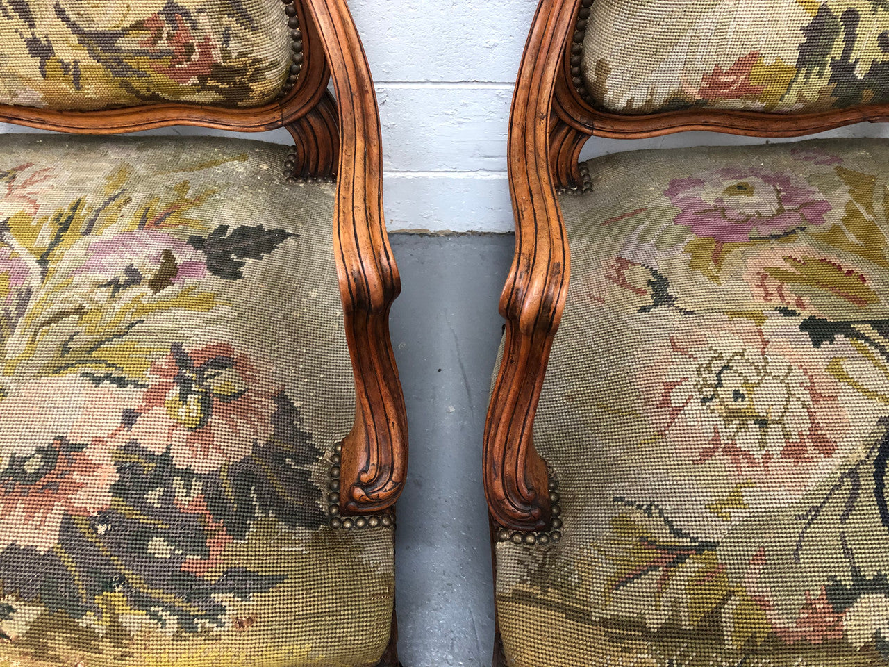Pair of French Walnut Tapestry covered armchairs. They are in good original detailed condition. Slight wear and tear to fabric but still in good condition please view photos.