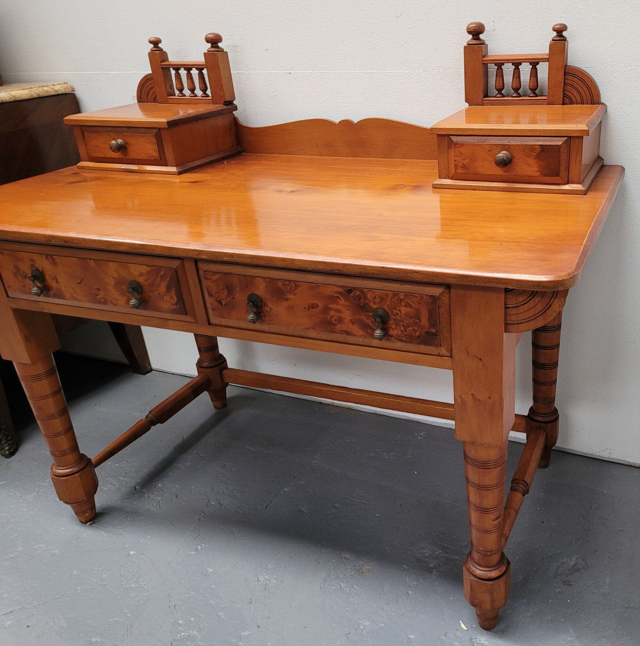 Late Victorian Huon Pine desk with two drawers. Featuring superb birdseye panels and is in good original detailed condition.
