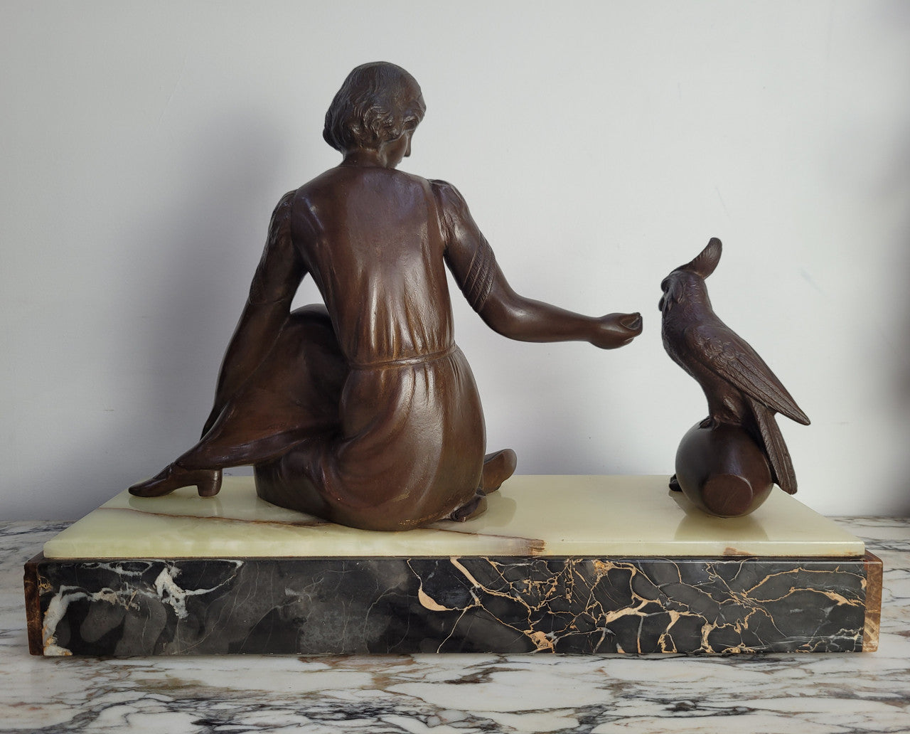 Art Deco bronze statue with brown patina of a lady and parrot on marble base. Signed by Italian Sculptor A Trefolini, an highly regarded sculptor, in very good condition.