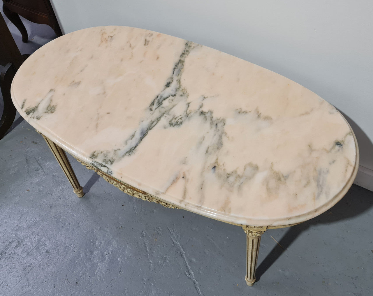 Charming painted Louis XVI style oval marble top coffee table. In good original detailed condition.