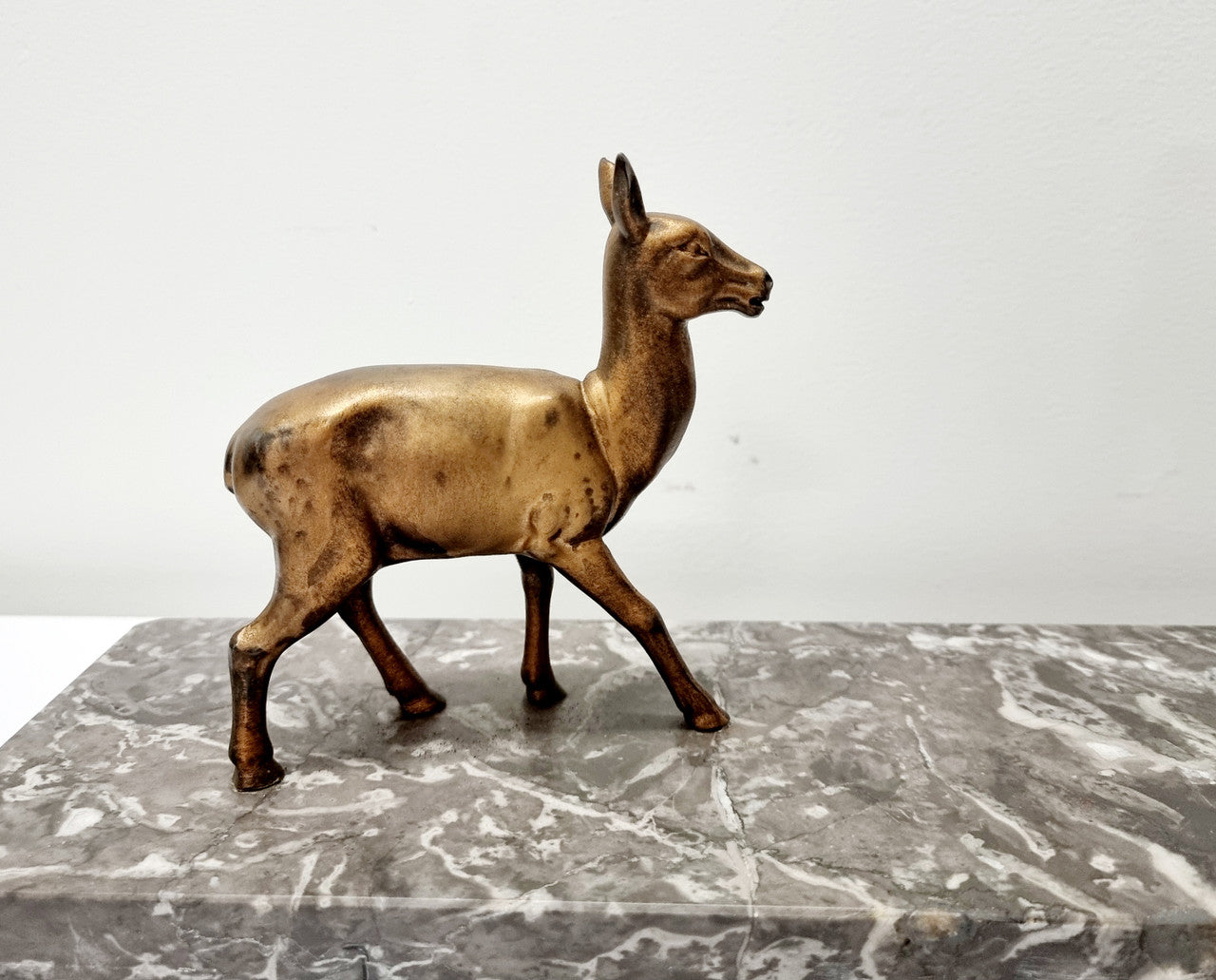 Art Deco gilt metal lady and deer statue on a lovely grey marble base. It has been sourced from France and is in good original condition. The marble does have some minor chips and wear due to age, please view photos as they help form part of the description. Please contact us if you would like additional photos.