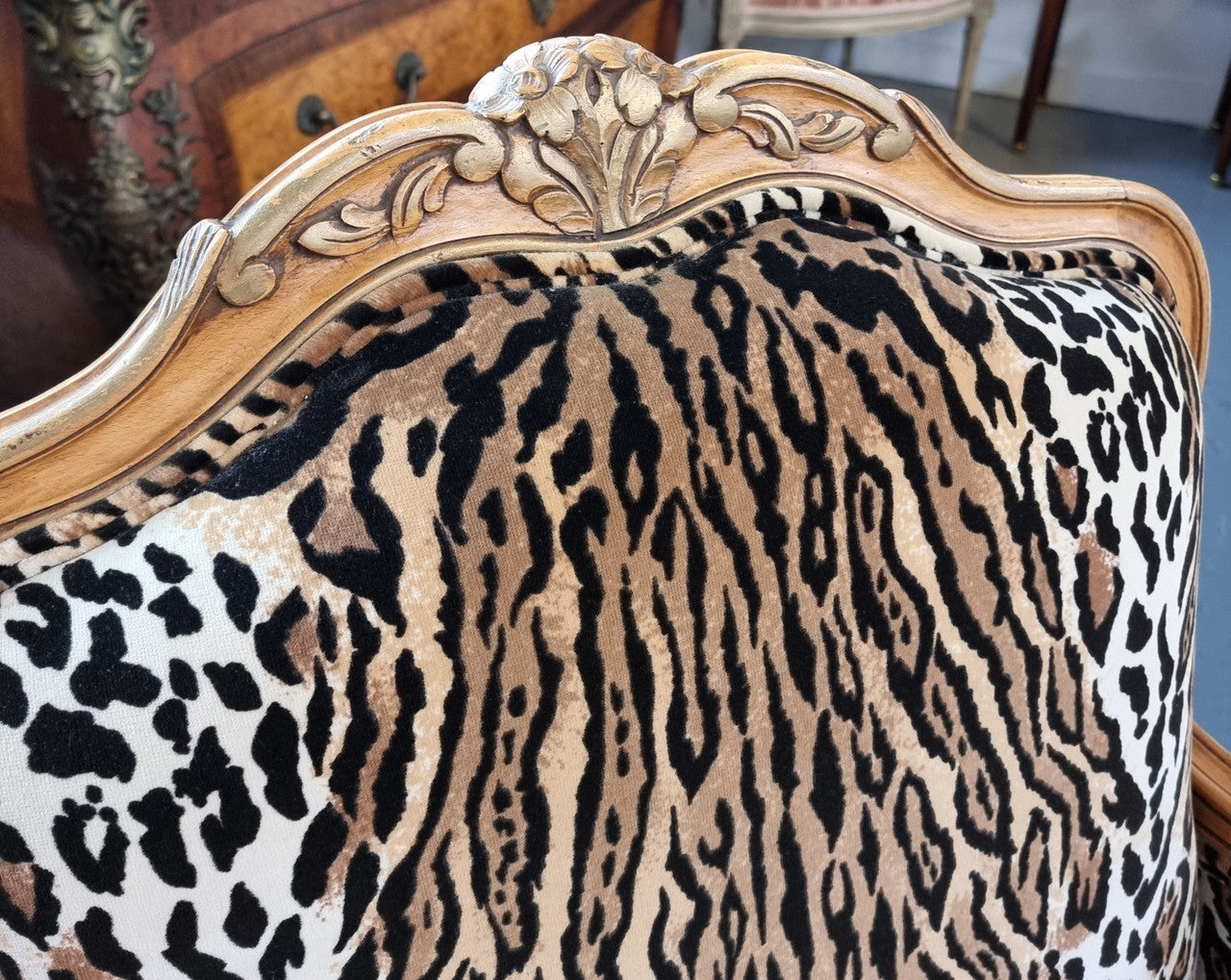 A French Louis XV style armchair with leopard print upholstery and with matched footstool. Fabric is in good original used condition. Please view photos as they help form part of the description.