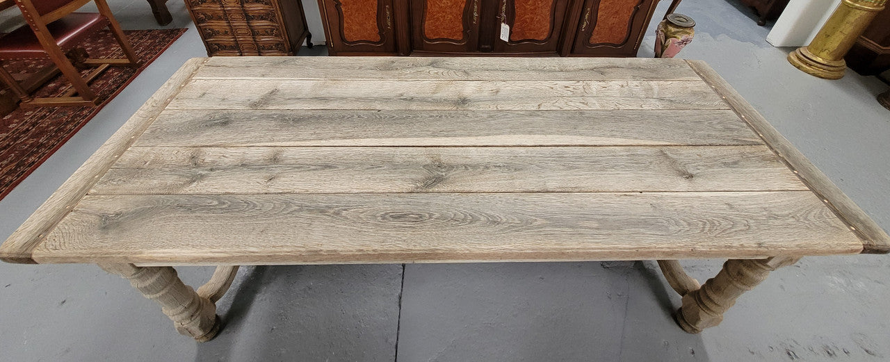 French stripped Oak pedestal stretcher base Farmhouse table with two drawers on either side of table. Features raw wood that could be used as is for a distressed look, or finished and waxed for a more refined look.