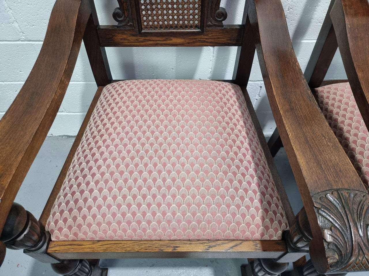 Pair oak Jacobean Revival carver chairs with cane back. In good restored condition with clean upholstery.