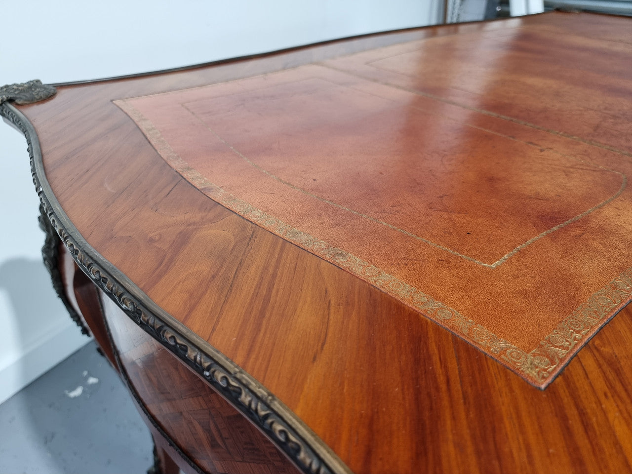 An impressive French kingwood and ormolu mounted bureau plat. It has a brown tooled leather writing surface, three decorated frieze drawers to the shaped apron with foliate swing handles and well cast figural mounts. Beautiful cabriole legs with decorative ormolu mounts and trims throughout. In good original detailed condition.
