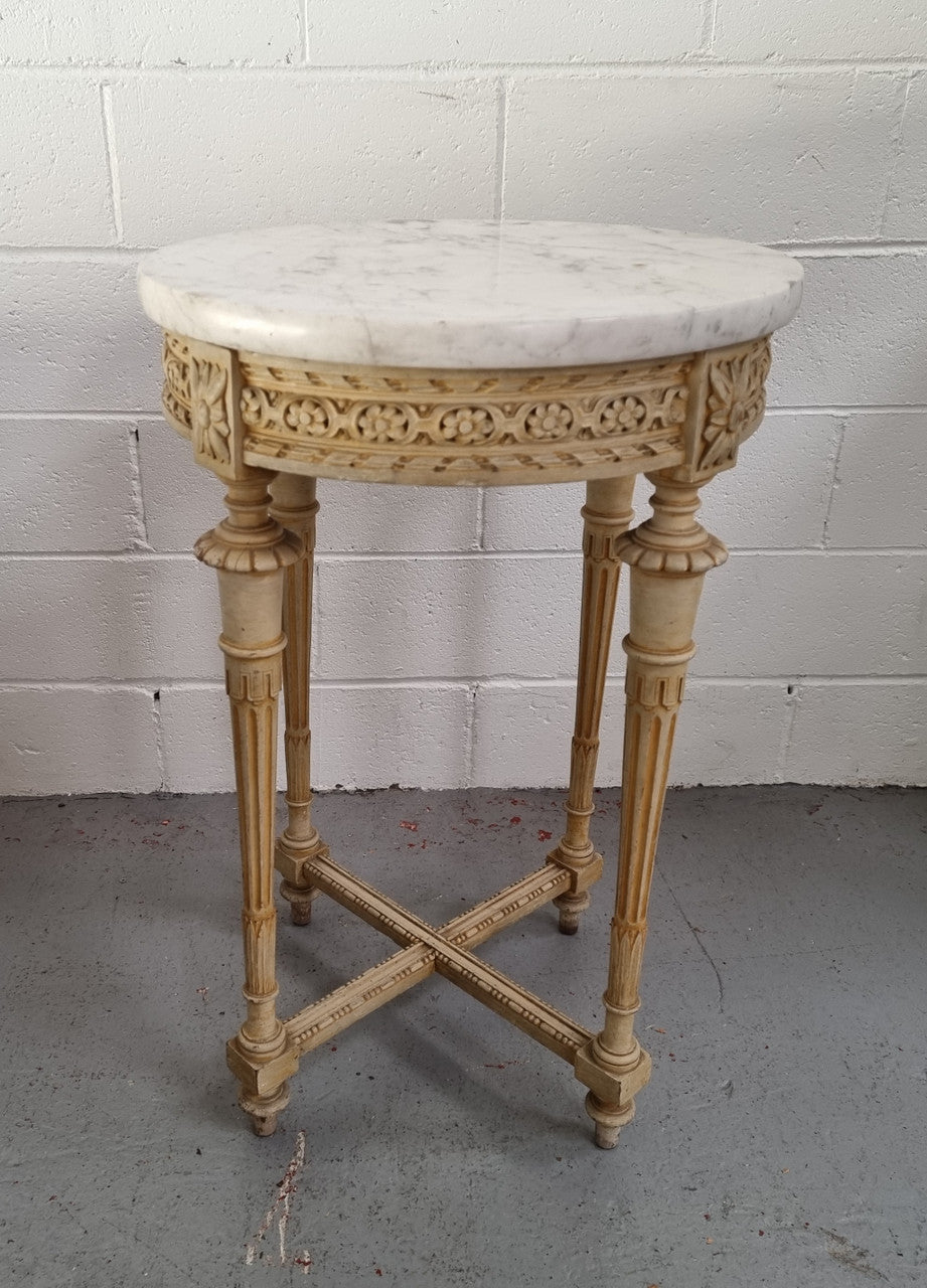 Louis XVI style round side table with original paint and a beautiful thick marble top. It is in good original detailed condition.