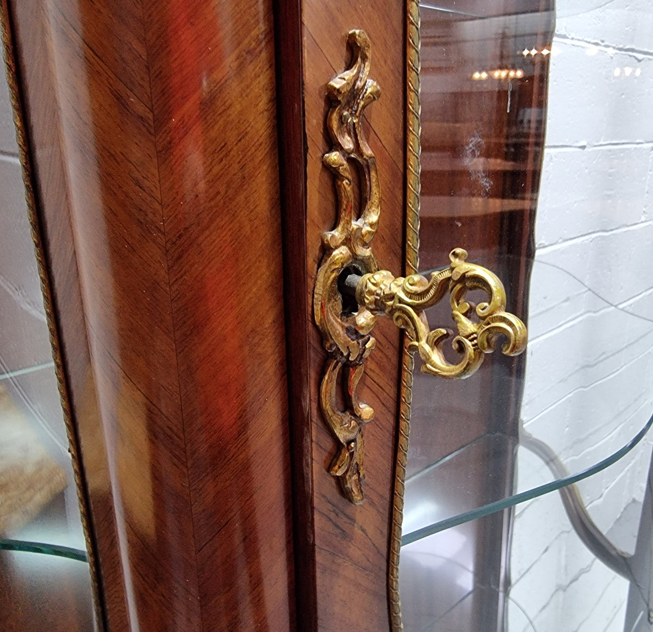 Grand French Walnut Louis XV style marble top vitrine. It has two glass shelfs and one mirrored shelf at the bottom and added storage at bottom. It is in good original detailed condition.