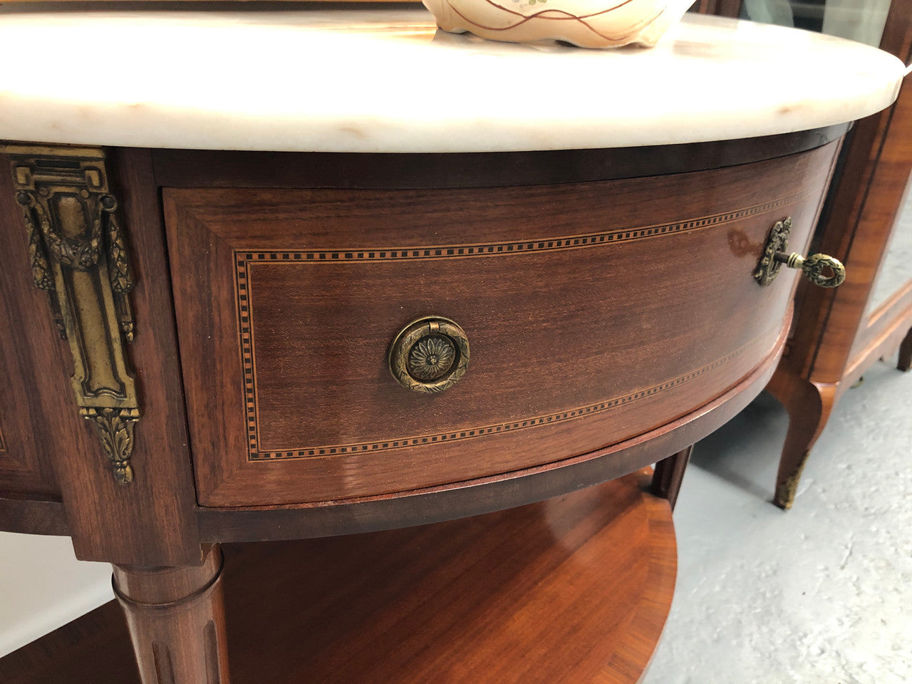 French marble top half round console table. It has beautiful marquetry inlay and ormolu mounts with a single drawer. In good original condition.