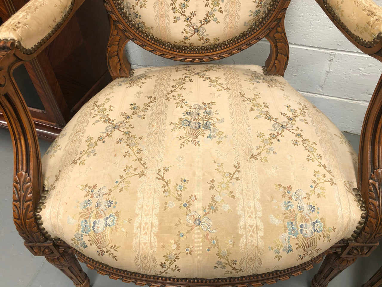 Pair of Antique French Louis XVI style carved Walnut fauteuils in restored condition. The Tapestry upholstery is in good condition some marks and wear but usable.