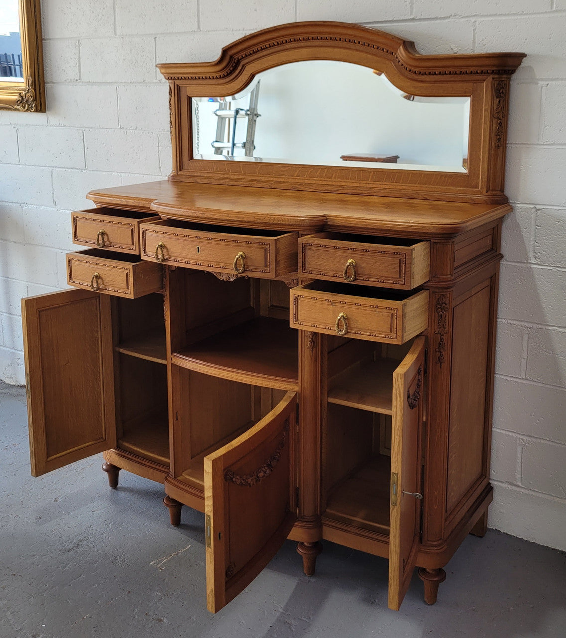 Beautiful French Oak Louis XVI Style nicely carved sideboard with a lovely parquetry top and mirror. It has five drawers and three cupboards for all your storage needs. In good original detailed condition.