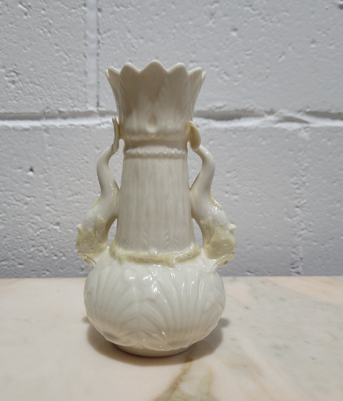 Vintage Belleek Double Handled Fish Vase. Scalloped shell pattern on base & delicate fish handles. Brown Mark 1980 – 1933.