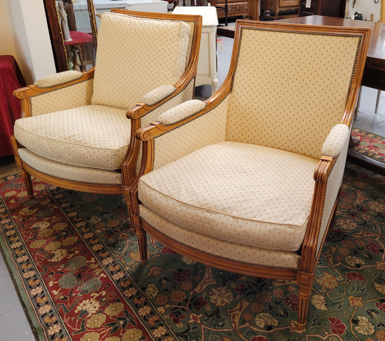 Pair of Louis XVI style 19th Century walnut upholstered Bergère chairs with loose cushions. They have been sourced from France and is in good original detailed condition. The fabric is in good original used condition, please view photos as they help form part of the description.