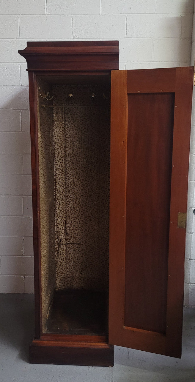 Unusual Victorian Flame Mahogany side wardrobe with side door. It has full hanging and six hooks. The wardrobe opens from a side door which can be locked with its key and has a markers mark stamp on the door. It is in good original condition.