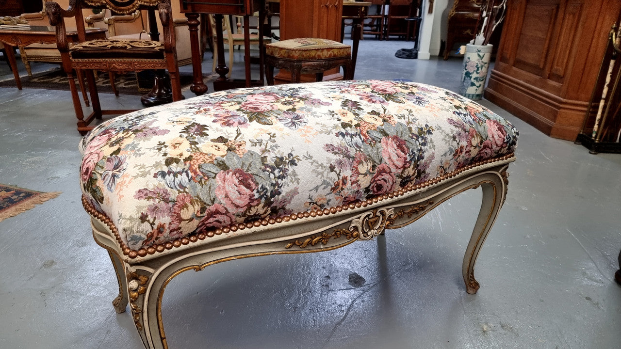 Antique painted Louis XV style upholstered stool. It has lovely floral upholstery that is in good condition with no tears. It is in good original detailed condition.