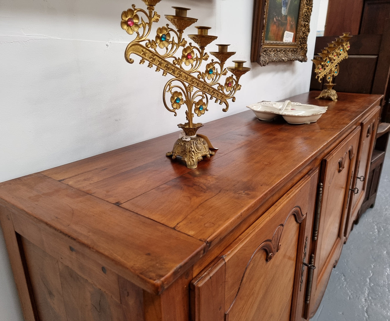 Early 19th Century Louis XV style Fruitwood three door sideboard. It has three hidden internal drawers and one of them has green valet and small sections for cutlery. It is in good restored condition.