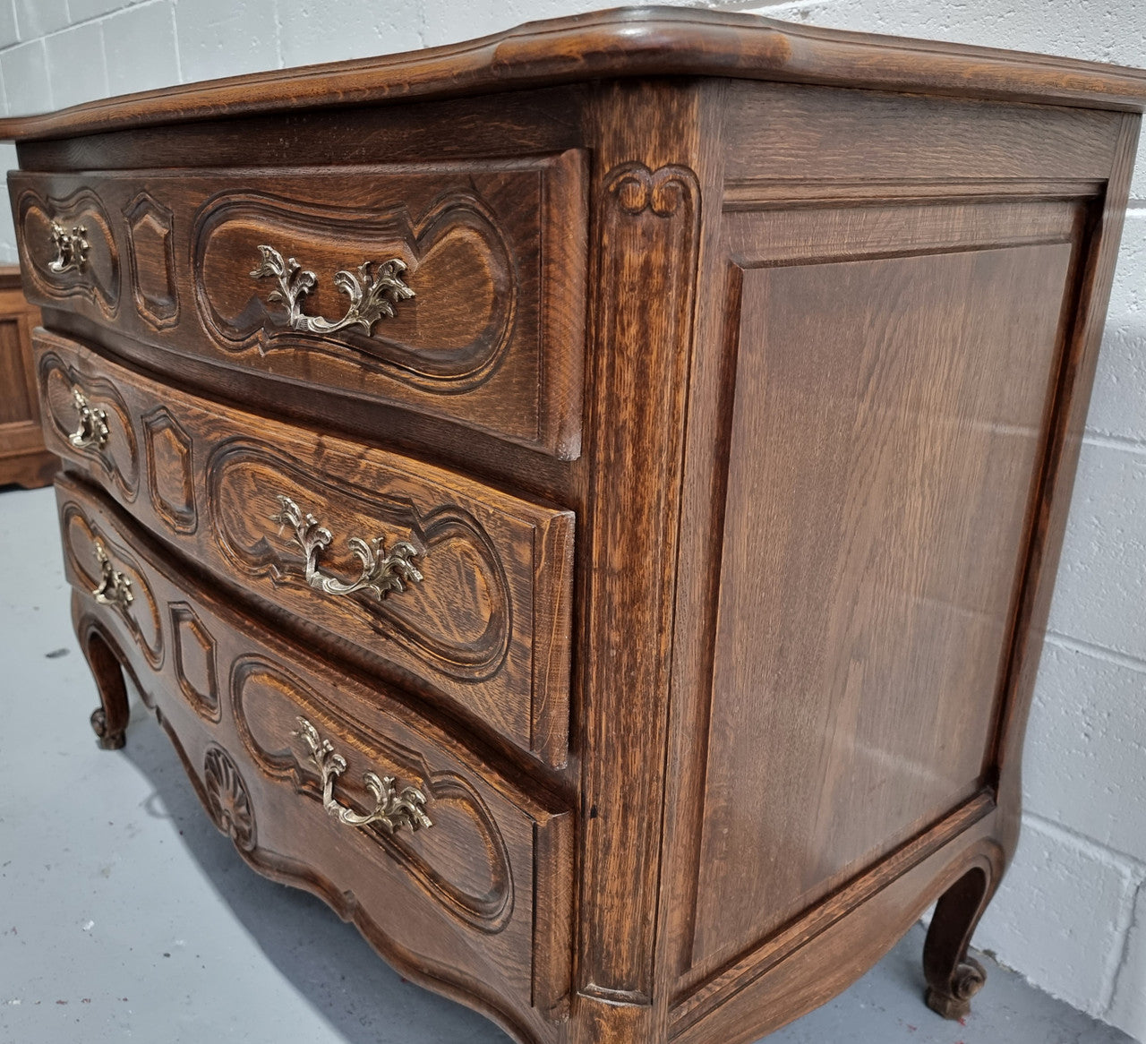 Lovely French nicely carved chest of 3 drawers with a parquetry top, with decorative handles and lovely carving. In good detailed condition.