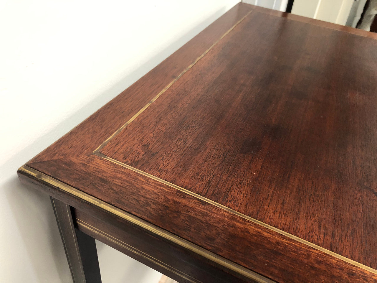 Elegant rectangular mahogany French brass inlaid occasional table. Is in good original condition.