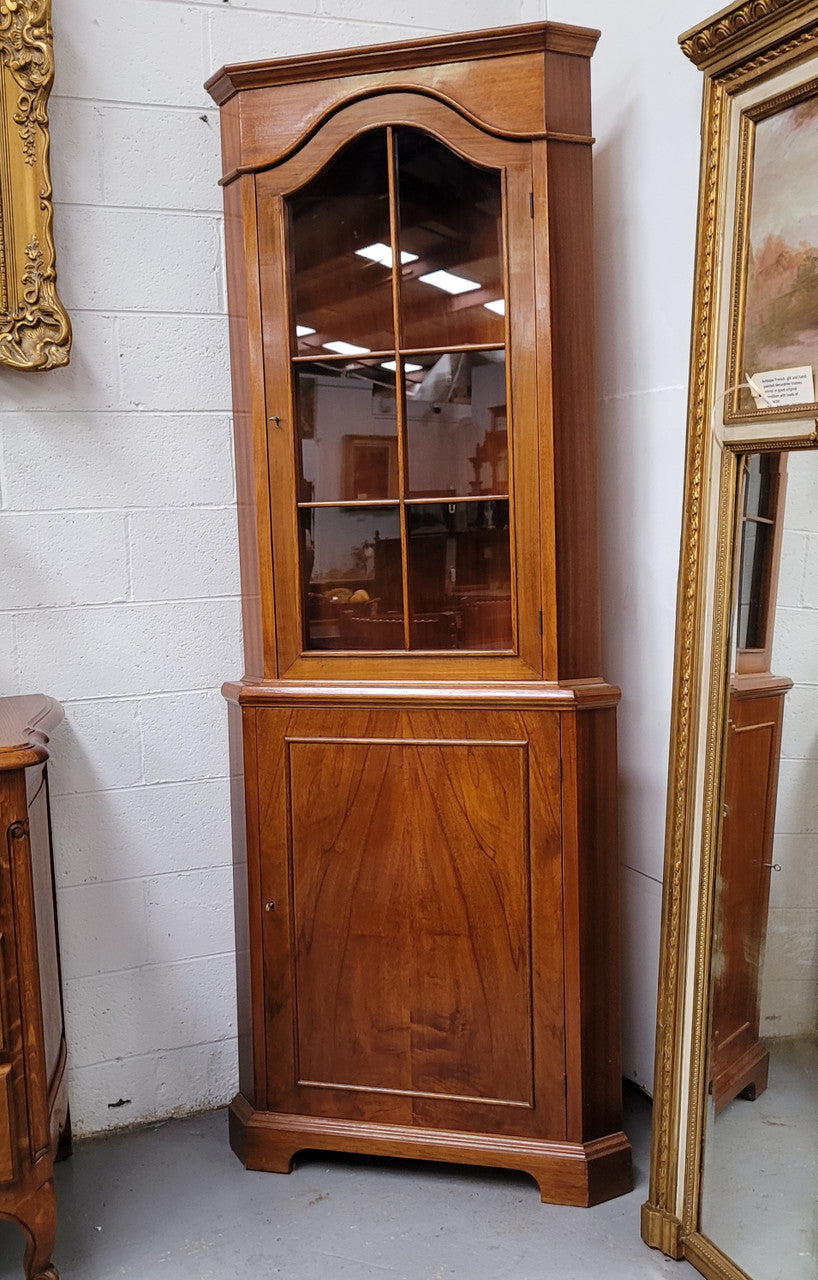 Practical Walnut corner cabinet with display and storage. Two shelf glass display on top and single shelf cupboard below. Sourced locally and in good original detailed condition.