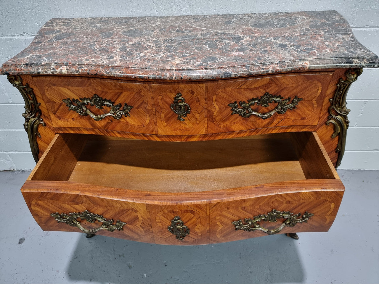 Attractive French marble top Louis XV style three drawer commode with decorative ormolu mounts. In good original detailed condition.