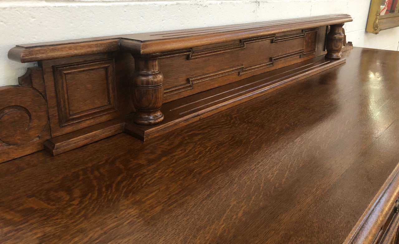 Beautiful carved French Oak four-door buffet with three drawers and lots of room for storage in good original detailed condition.