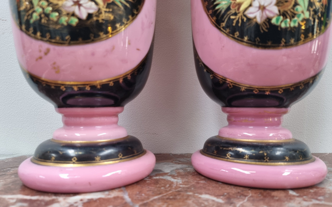 Late Victorian pink and hand painted, enameled pair of vases with some ware to enameling. It is in good original condition.