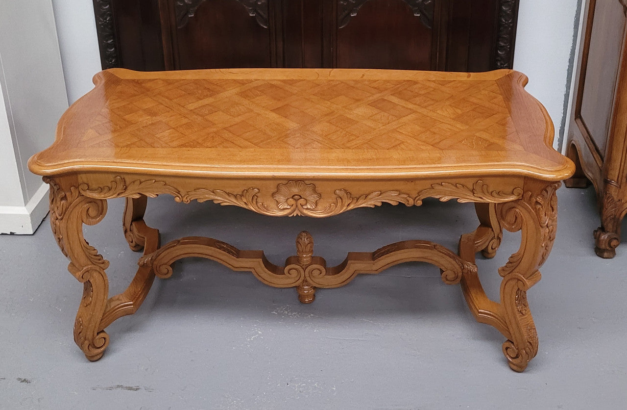 French Oak parquetry top coffee table with decorative carved base. It is in good original detailed condition.