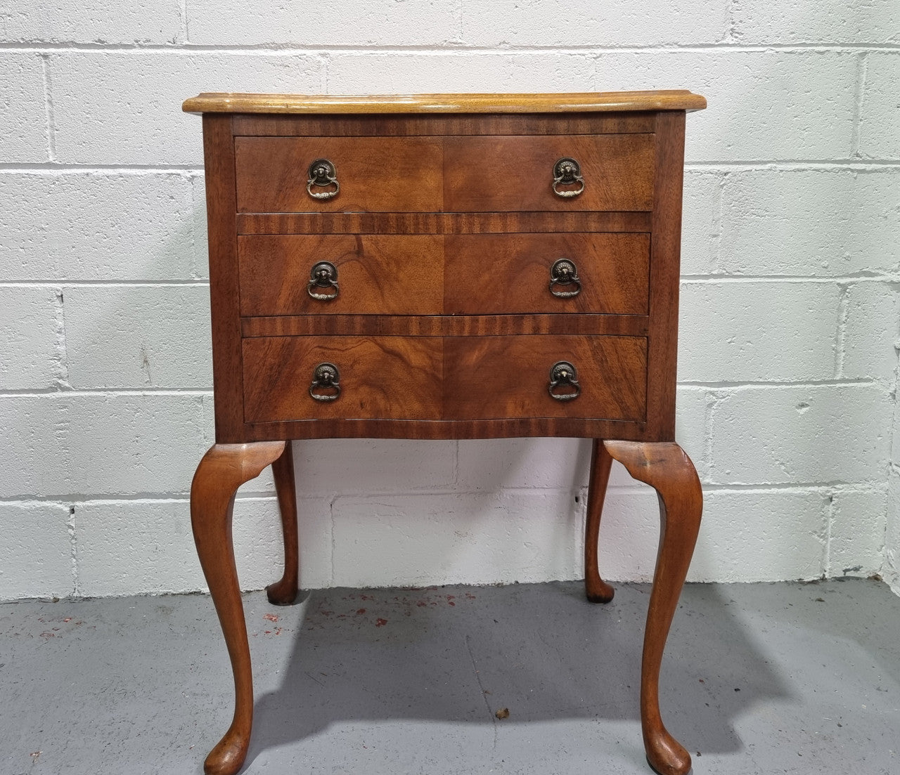 Antique Queen Anne style figured Walnut Bedside cabinet with 3 drawers. It is in good original detailed condition.