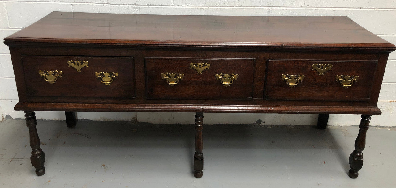 Early 19th Century English Oak dresser base with three large drawers. In very good original detailed condition.
