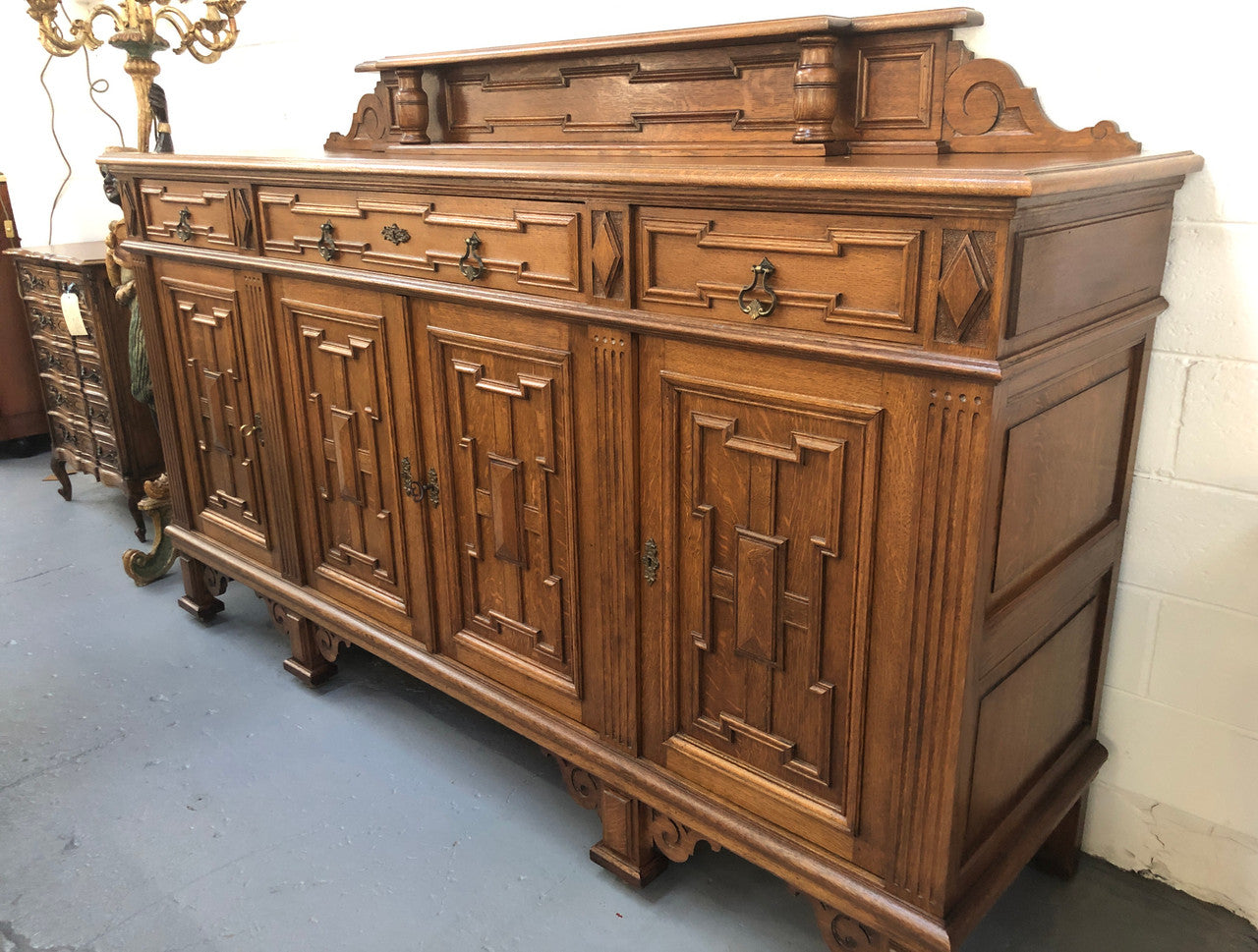 Beautiful carved French Oak four-door buffet with three drawers and lots of room for storage in good original detailed condition.