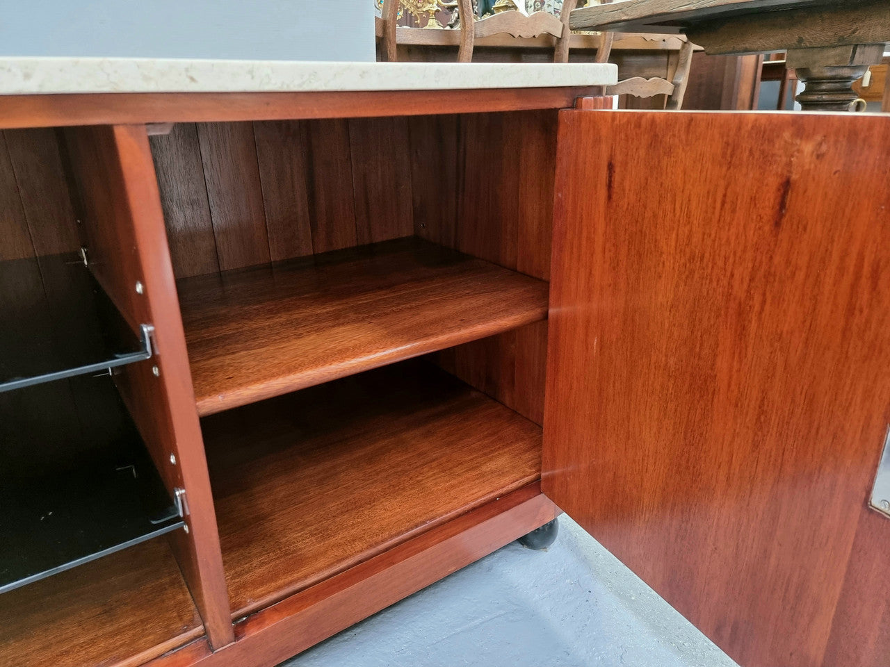 Beautiful Bespoke Art Deco style walnut and mahogany low line cabinet with a marble top and plenty of storage. It has two doors with a shelf each side and in the middle in has two glass shelves. Would make an ideal TV cabinet and has a hole in the back to run cords through. In very good original detailed condition.