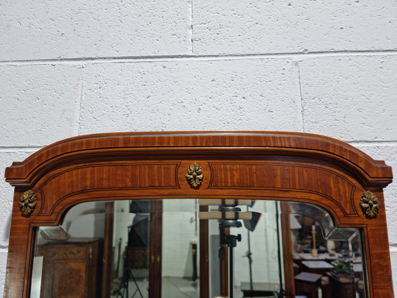 Decorative late 19th Century mahogany French wall mirror with brass swivel candle holders and brass detail. In good original detailed condition.