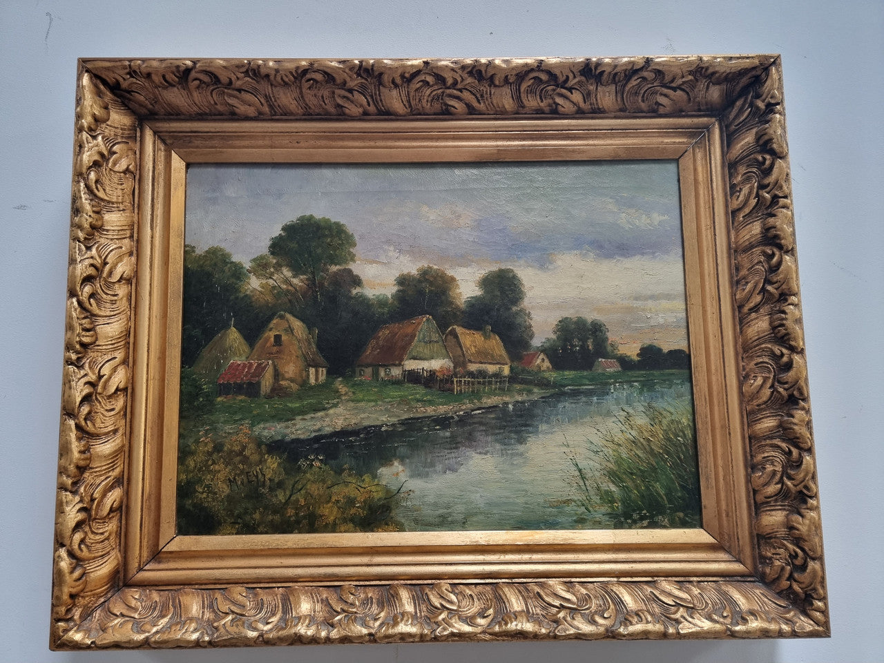 Lovely framed original oil on canvas of a country cottage scene on a river in good original condition
