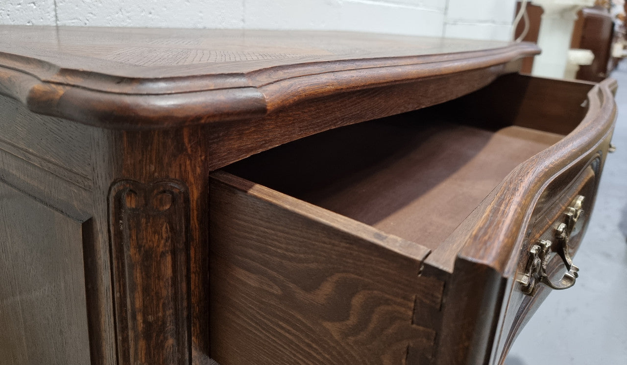 Lovely French nicely carved chest of 3 drawers with a parquetry top, with decorative handles and lovely carving. In good detailed condition.