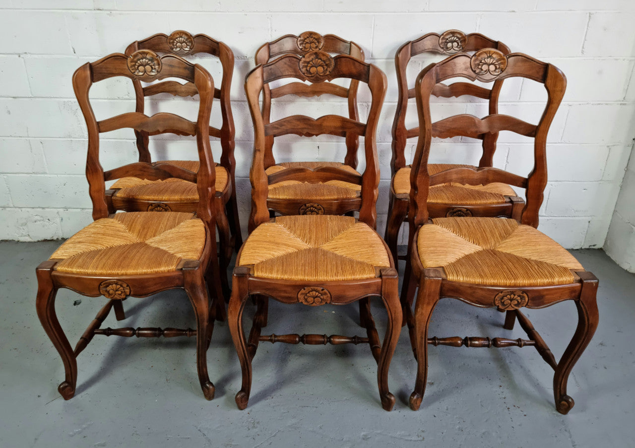 Set of six French Cherrywood rush seat dining chairs. In good restored condition.