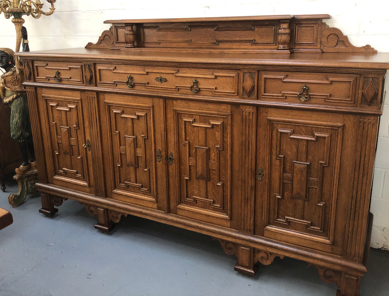 Beautiful carved French Oak four-door buffet with three drawers and lots of room for storage in good original detailed condition.