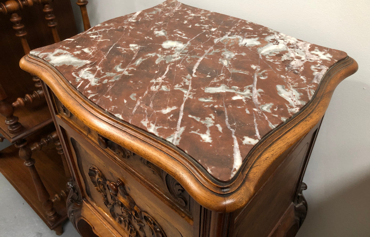 Single French carved bedside with inset marble top. It has beautiful carving and a drawer and cupboard for storage. In very good original detailed condition.