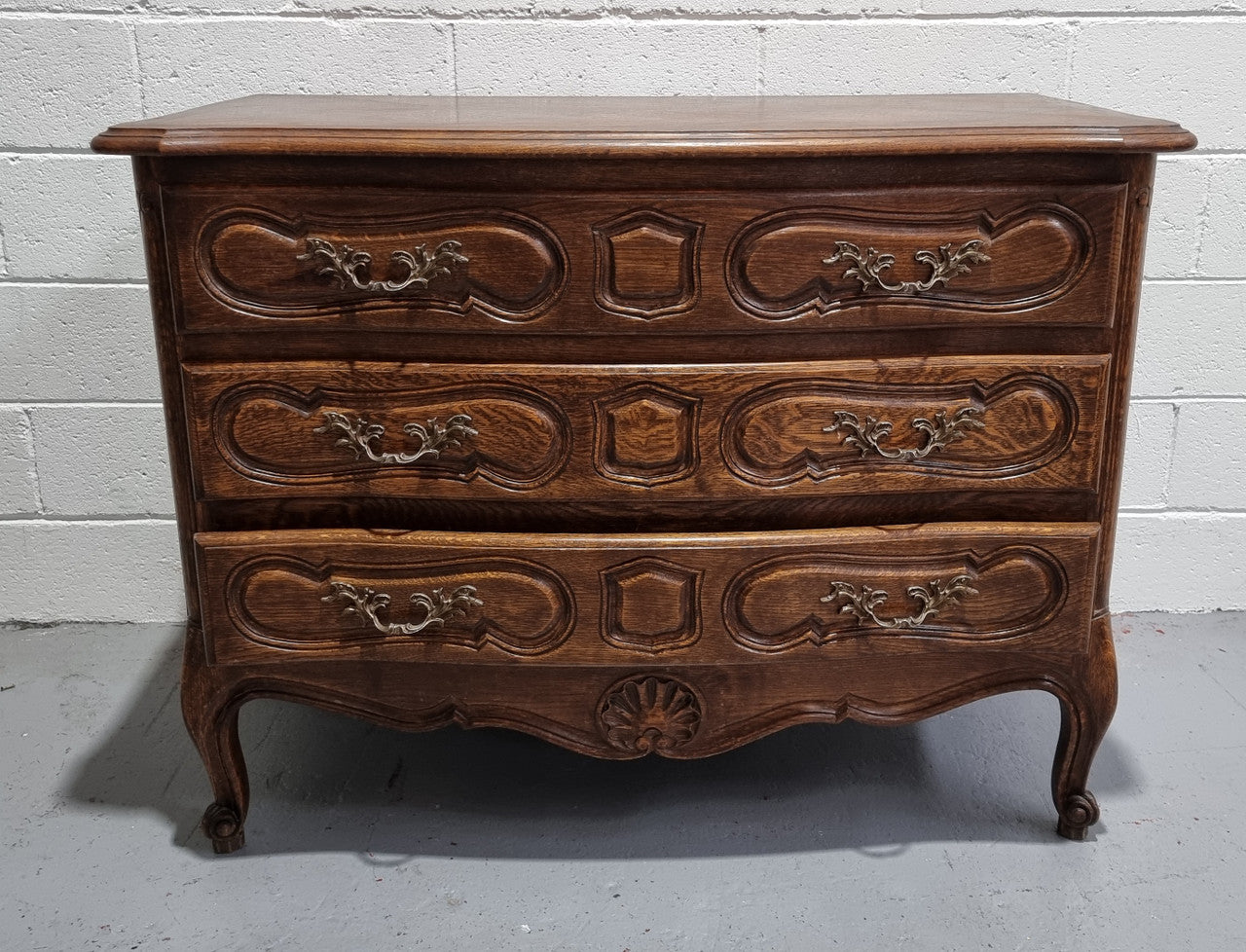 Lovely French nicely carved chest of 3 drawers with a parquetry top, with decorative handles and lovely carving. In good detailed condition.