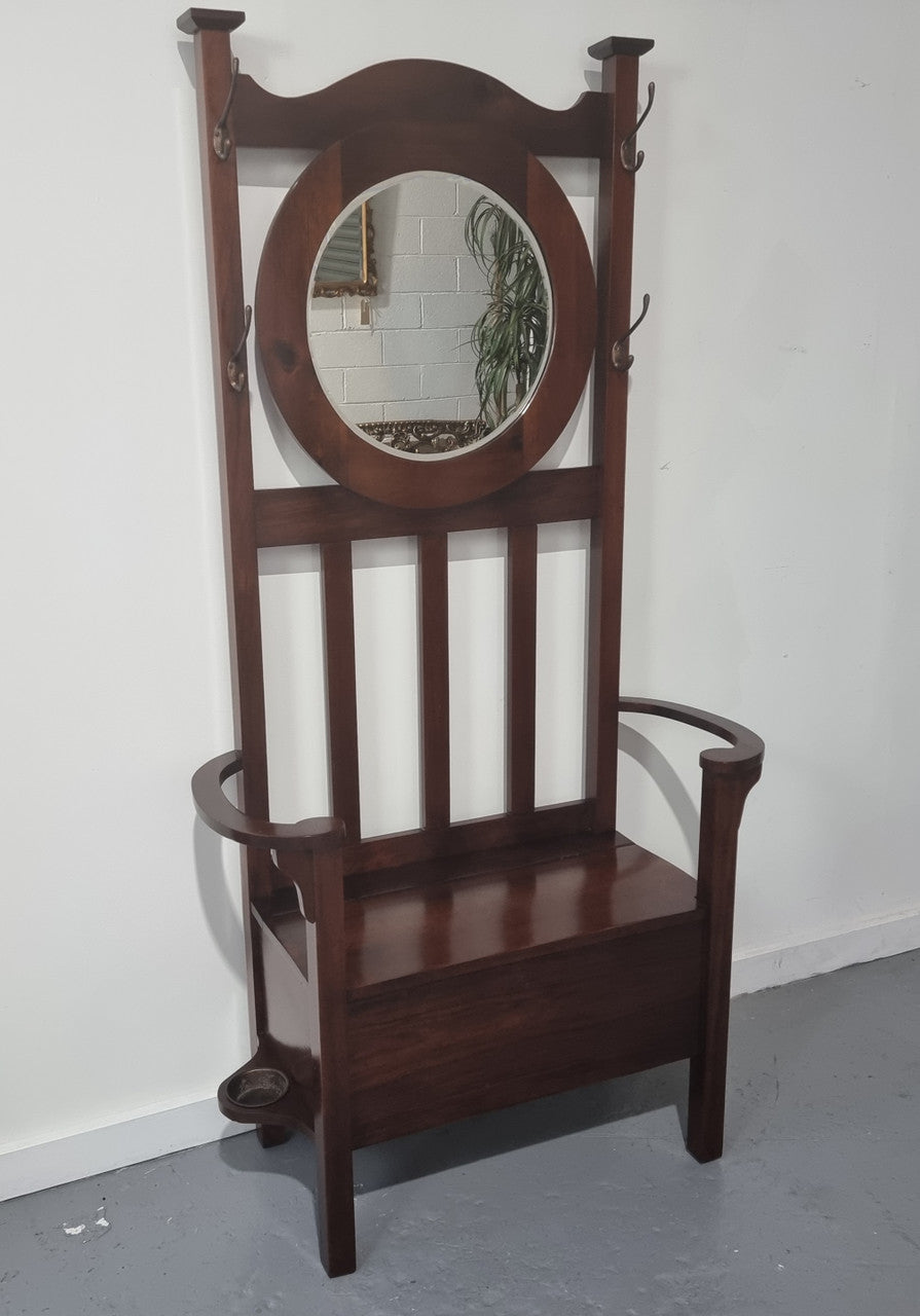 Blackwood Federation hall stand of pleasing narrow proportions. Beautiful round mirror with four lovely hooks and a lift up sit for added storage. In good original condition.