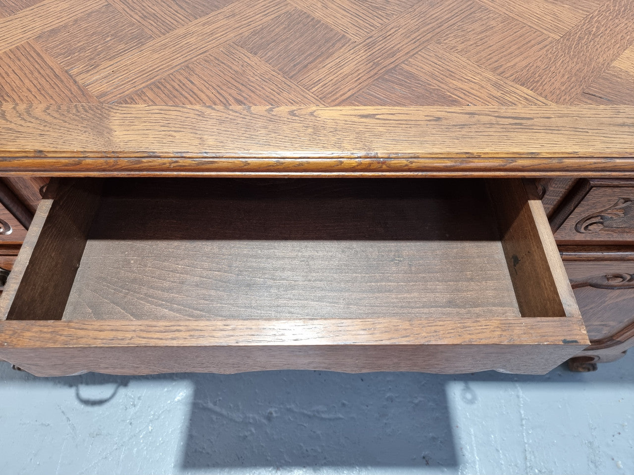 Beautifully carved french oak, faux partners desk with a lovely parquetry top and 6 drawers and 1 cupboard . In good original condition.