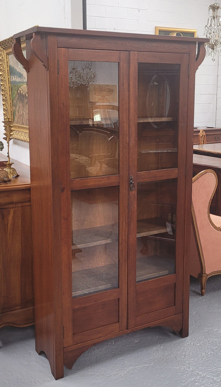 Beautiful two door Blackwood bookcase with glass doors and with four fully adjustable shelves. It is in good original detailed condition.