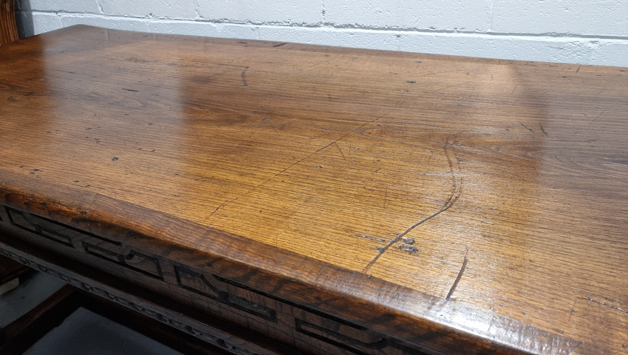 Rare and Charming 17th Century Spanish Walnut serving / side table. It has an incredible one piece walnut top with amazing character and colour. The base displays the original patina aswell as three drawers with carving and remnants of original locks. Superbly turned legs terminating on a stretcher base. Could be used as a large entrance console table, a side table or in a dining area as a serving table. In good original detailed condition especially considering its age.