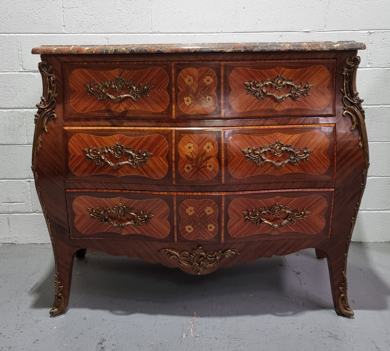 French Walnut and Kingwood Louis XV style marquetry inlaid commode with three drawers and a beautiful marble top. It is in good original detailed condition.